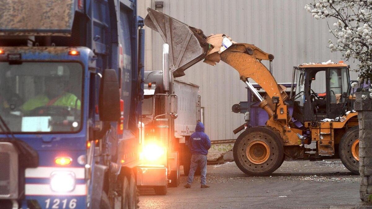 A refuse disposal truck in operation. Fresno Bee File photo.